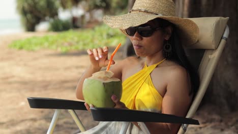 Asian-Woman-Enjoying-The-View-While-Drinking-Fresh-Coconut-Juice
