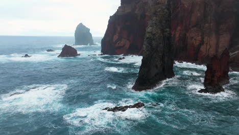 Cliffs-Of-Red-Volcanic-Rock-In-Ponta-de-Sao-Lourenco,-Madeira,-Portugal---aerial-drone-shot