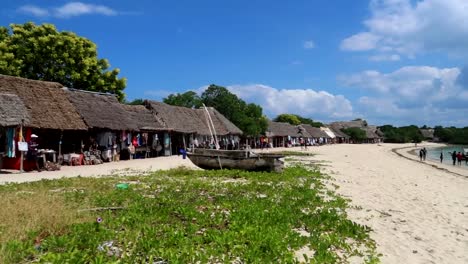 Pan-right-shot-over-local-bungalow-shops,-and-local-stores-on-the-beach-side-in-Zanzibar,-Africa