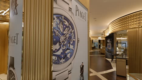 Luxurious-golden-watch-shop-interior-shot-moving-around-Piaget-mechanical-wristwatch-sales-display