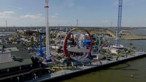 Aerial-view-around-the-Flare-a-seven-story-looping-roller-coaster-in-Kemah-Boardwalk,-in-sunny-Texas,-USA