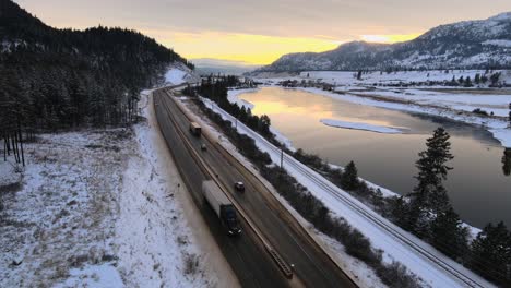 Highway-1-and-Thompson-River-in-Kamloops,-BC,-with-Mountains-in-the-Background-at-Sunset