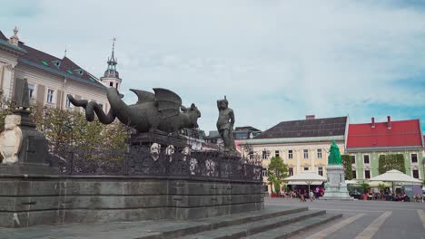 The-Lindwurmbrunnen-fountain-at-New-Square,-Klagenfurt,-Carinthia,-Austria-with-Hercules-statue-and-Maria-Theresien-momument
