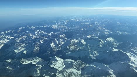 Panoramic-side-view-of-the-Pyrenees-mountains-from-a-jet-cockpit-while-flying-northound-at-12000m-high