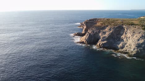 Amazing-aerial-view-of-cliff-in-Mediterranean-sea,-forward,-wide-shot,-day