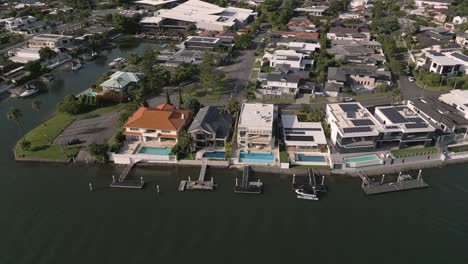 5-February-2023---Aerial-views-over-houses-in-the-canals-in-Surfers-Paradise,-Gold-Coast,-Queensland,-Australia
