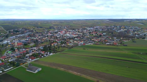 Aerial-Panoramic-View-Of-Countryside-Town-With-Vast-Evergreen-Fields