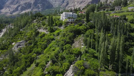Aerial-View-of-Small-Hotel-Building-in-Landscape-of-Hunza-Valley-Pakistan,-Drone-Shot