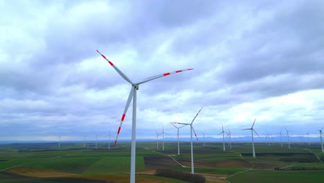 Scenic-View-Of-Wind-Turbine-Against-Clouded-Horizon-In-Rural-Farm-Landscape