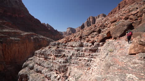 Grand-Canyon-National-Park,-Arizona-USA,-Female-Hiker-Walking-on-Dangerous-Hiking-Trail,-Slow-Motion