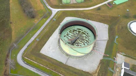 Aerial-View-Of-Oil-Storage-Tank-With-Rusted-External-Floating-Roof