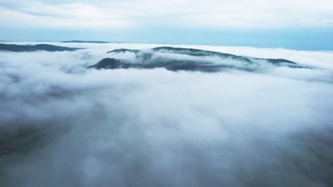 The-foggy-aerial-view-stock-footage-of-Banska-Bystrica,-The-soft,-white-fog-blankets-the-hillsides,-creating-a-tranquil-and-peaceful-ambiance