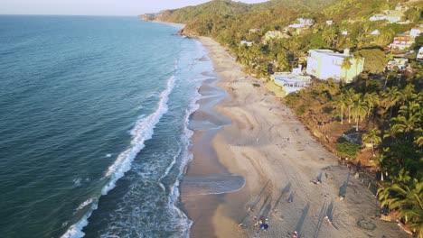 A-drone-views-the-Northern-stretch-of-Sayulita-beach-of-the-Pacific-Ocean-in-Mexico-with-a-new-hotel-under-construction