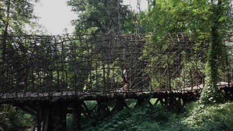 Bridge-of-San-Vigilio,-natural-structure-with-person-standing,-aerial,-dolly-out