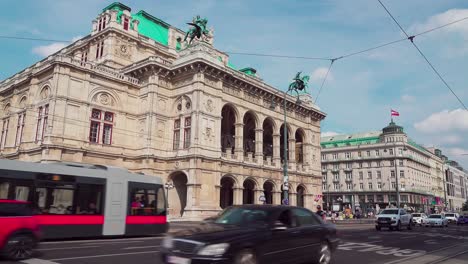 Tram-and-cars-driving-by-on-the-Opernring-outside-Vienna-State-Opera-in-the-city-center-of-Vienna