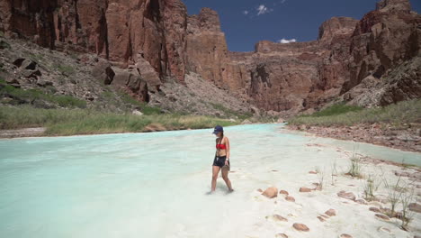 Young-Woman-Walking-in-White-Mud-by-Turquoise-Water-of-Little-Colorado-River,-Grand-Canyon-National-Park,-Arizona-USA,-Slow-Motion