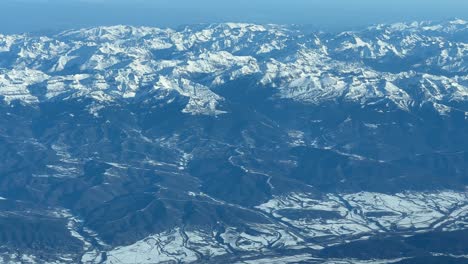 Aerial-view-from-a-jet-cockpit,-pilot-point-of-view,-of-the-snowed-Pyrenees-mountains-flying-from-Spain-to-France-at-1000m-high