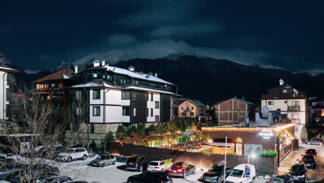 Timelapse-at-snowy-night-in-Bansko-with-hotels-and-mountain-in-background