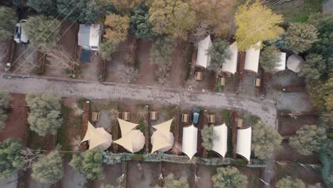 rising-drone-flight-over-typical-small-tents-and-parking-near-the-Canales-Reservoir-in-Güéjar-Sierra-in-spain