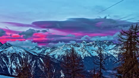 Colorful-pink-sunrise-beyond-the-rugged-mountain-peaks-of-the-Alps---time-lapse