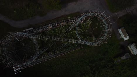 Top-down-aerial-view-of-creepy-abandoned-LunaPark,-rising-above-roller-coster