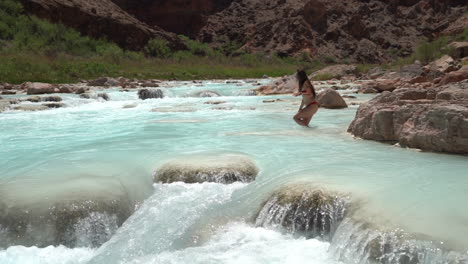 Woman-in-Bikini-Goin-In-Turquoise-River-Water,-Hopi-Salt-Trail,-Grand-Canyon-National-Park-USA