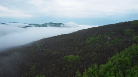 Aerial-view-of-Banska-Bystrica-in-Slovakia-captivating-journey-above-the-city-and-its-surroundings,-showcasing-the-dreamy,-almost-mystical-atmosphere-that-emerges-from-the-mist