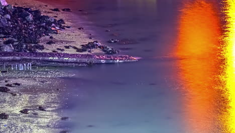 Ein-Großer-Blaureiher-Watet-Im-Meerwasser,-Während-Die-Flut-Steigt-Und-Der-Sonnenuntergang-Vom-Wasser-Reflektiert-Wird-–-Zeitraffer