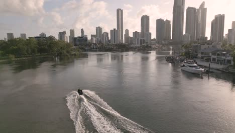 5-February-2023---Aerial-views-over-jetski-on-Nerang-River-in-Surfers-Paradise,-Gold-Coast,-Queensland,-Australia