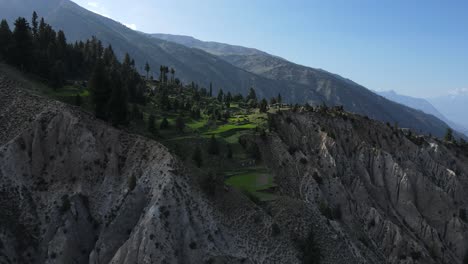 Aerial-View-of-Cliff-Top-Village-and-Green-Fields-in-Northern-Pakistan
