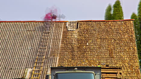 Time-lapse-shot-of-man-on-ladder-uncover-Roof-tiles-of-house-roof-during-sunset-time