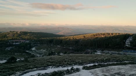 Aerial-shot-advancing-flying-over-a-snowy-forest-in-a-mountainous-landscape-in-Manzaneda,-Galicia