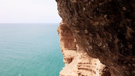 Rugged-Cliffs-And-Turquoise-Ocean-In-Cape-Kaliakra,-Bulgaria---tilt-down