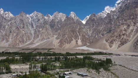 Northern-Pakistan-Mountains,-Aerial-View-of-Hunza-Valley-and-Snow-Capped-Summits-on-Sunny-Day