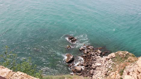Small-Waves-Splashing-On-Rocks-In-Cape-Kaliakra,-Bulgaria---slow-motion,-high-angle