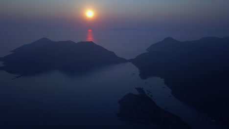 Ethereal-deep-blue-and-orange-ocean-sunset-aerial:-dark-dusk-islands
