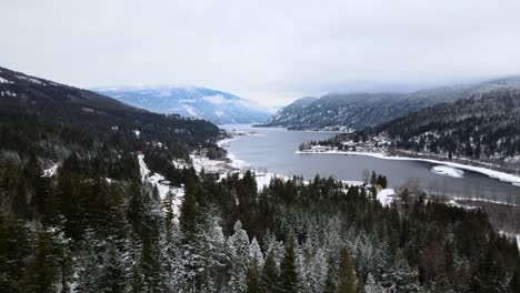 Stunning-View-of-Snow-Covered-Forest-and-Adams-Lake,-Overcast-Sky-in-the-Background