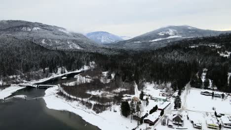 Spectacular-View-of-Winter-Landscape-of-Adams-Lake-and-Snowy-Forests,-Aerial-Drone-Shot-with-Overcast-Sky