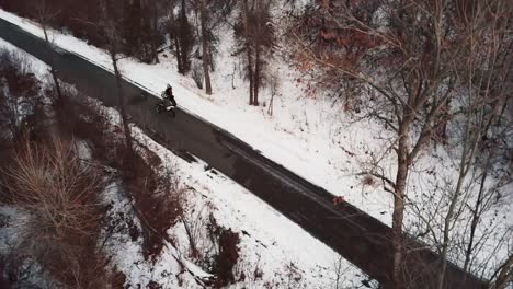 Driving-Motorcycle-On-The-Road-Through-Snow-covered-Forest-In-Wasatch-Range,-Near-Hobble-Creek-Canyon-In-Utah-At-Winter