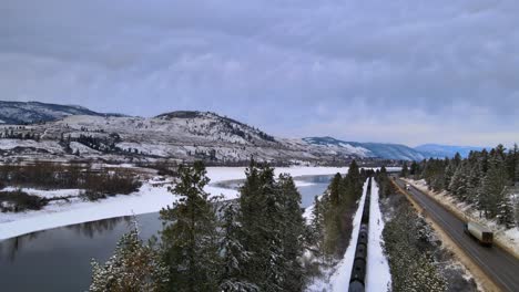 A-Majestic-Cargo-Train-Rolls-Alongside-the-Thompson-River-and-Highway-1-in-British-Columbia's-Winter-Wonderland