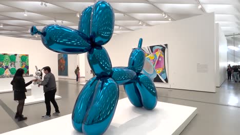Balloon-Dog-large-sculpture-in-museum-gallery-by-artist-Jeff-Koons