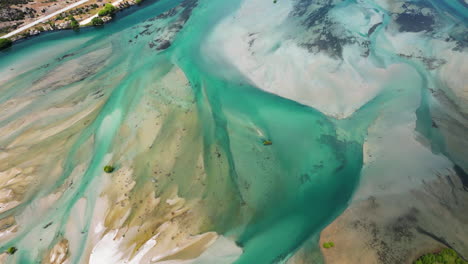 Shallow-blue-color-river-of-New-Zealand,-aerial-top-down-view