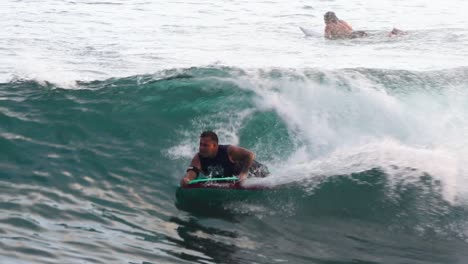 Bodyboarder-rides-a-clean-line-spraying-white-wash-off-the-top-of-the-wave