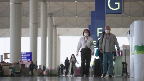 Travel-passengers-look-for-airline-check-in-desks-located-at-the-departure-hall-in-Hong-Kong's-Chek-Lap-Kok-International-Airport