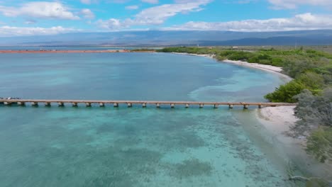 Aerial-forward-over-turquoise-waters-and-jetty-of-Cabo-Rojo-beach,-Dominican-Republic