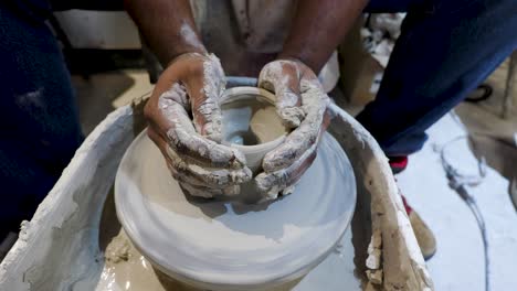 overhead-close-view-of-an-African-American-hands-spinning-clay-very-sporadically