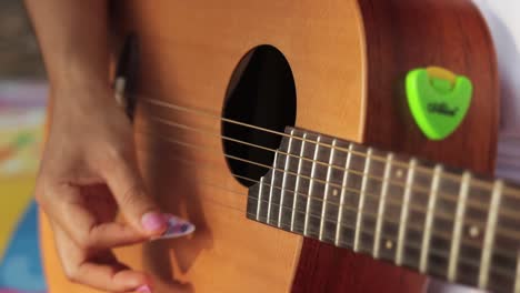 Closeup-Of-Female-Hands-Plucking-Guitar-Strings