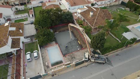 aerial-view-above-the-spraying-of-a-concrete-platform-for-the-construction-of-a-new-building
