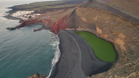 Majestic-areal-view-of-El-Charco-verde-black-beach-at-Lanzarote,-Canary-Island