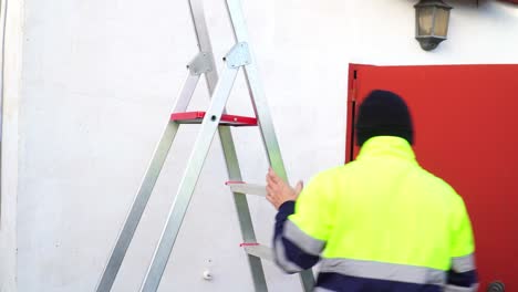 Maintenance-Guy-Wearing-Uniform-Setting-Up-His-Ladder-To-Work